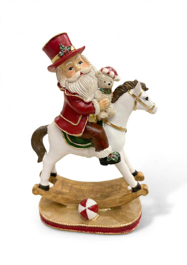 Babbo e mamma Natale sul cavallo a dondolo